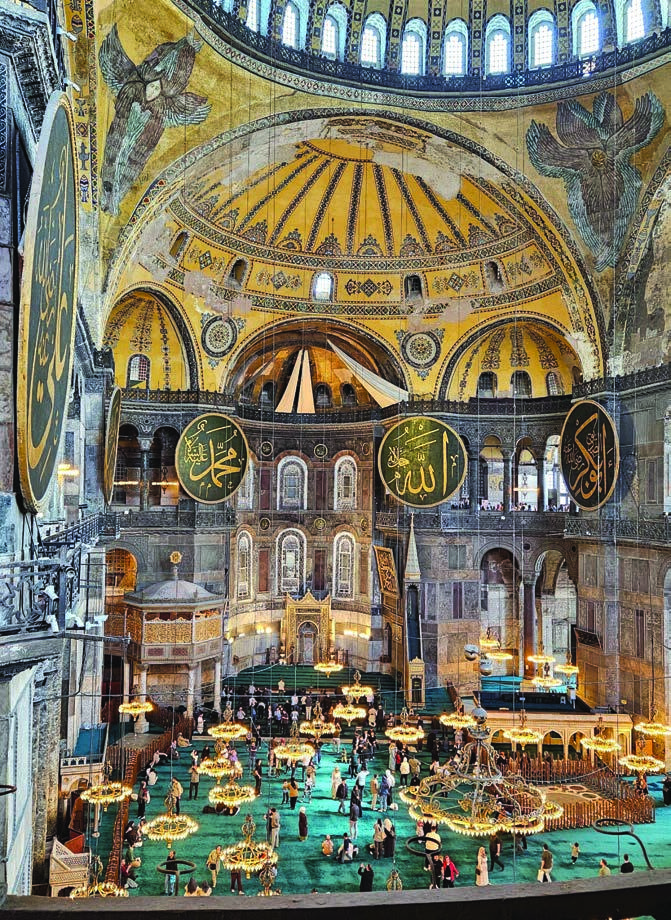 Hagia Sophia's carpeted prayer hall with curtains over the apse mosaic